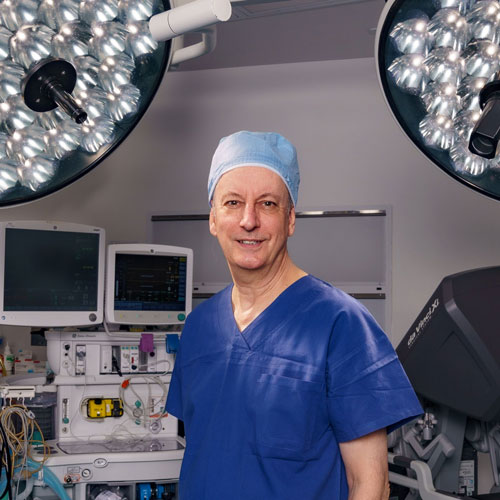 Portrait photo of Dr Graham Coombes in scrubs in the operating theatre.